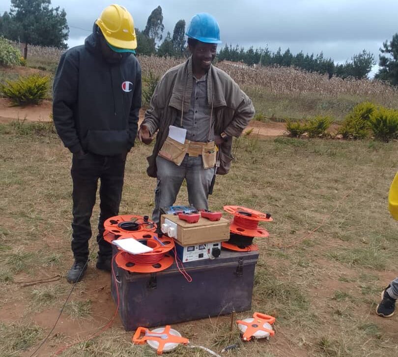 Dauson and a colleague performing and underground water survey